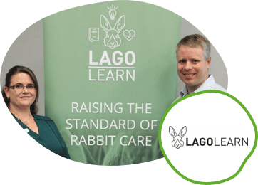 Two people standing in front of a Lago Learn banner